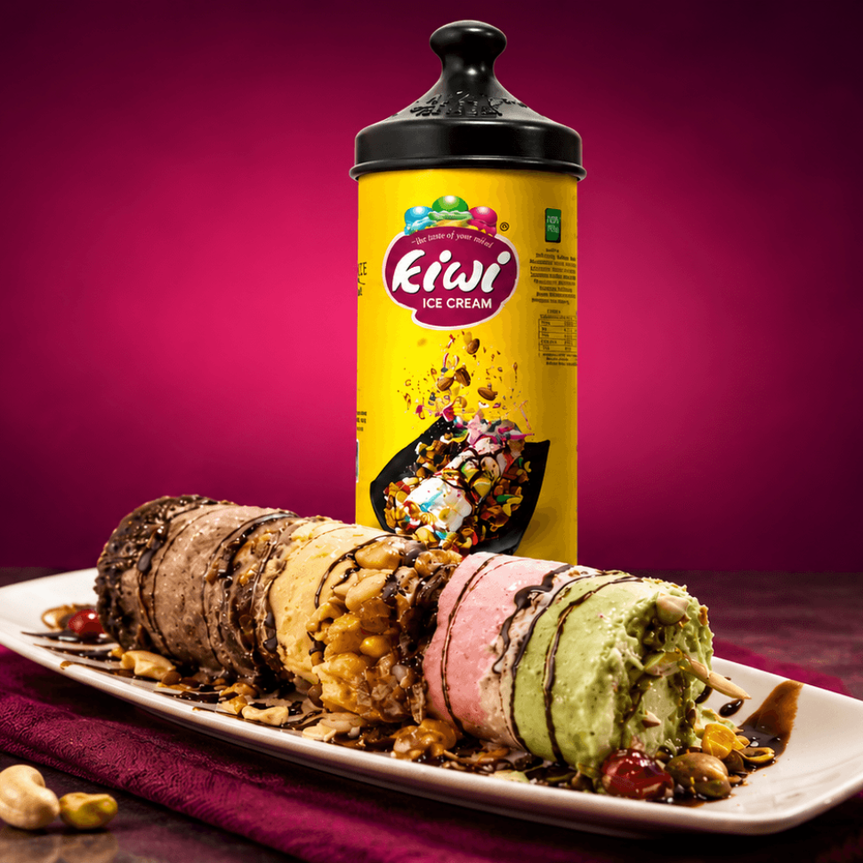 Kiwi Ice Cream Puttu with assorted flavors, nuts and chocolate drizzle